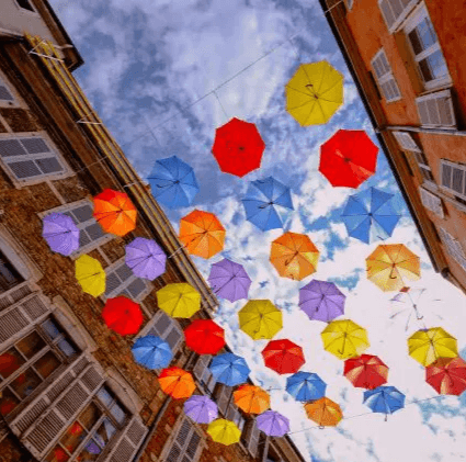 Colorful umbrellas suspended over a city street