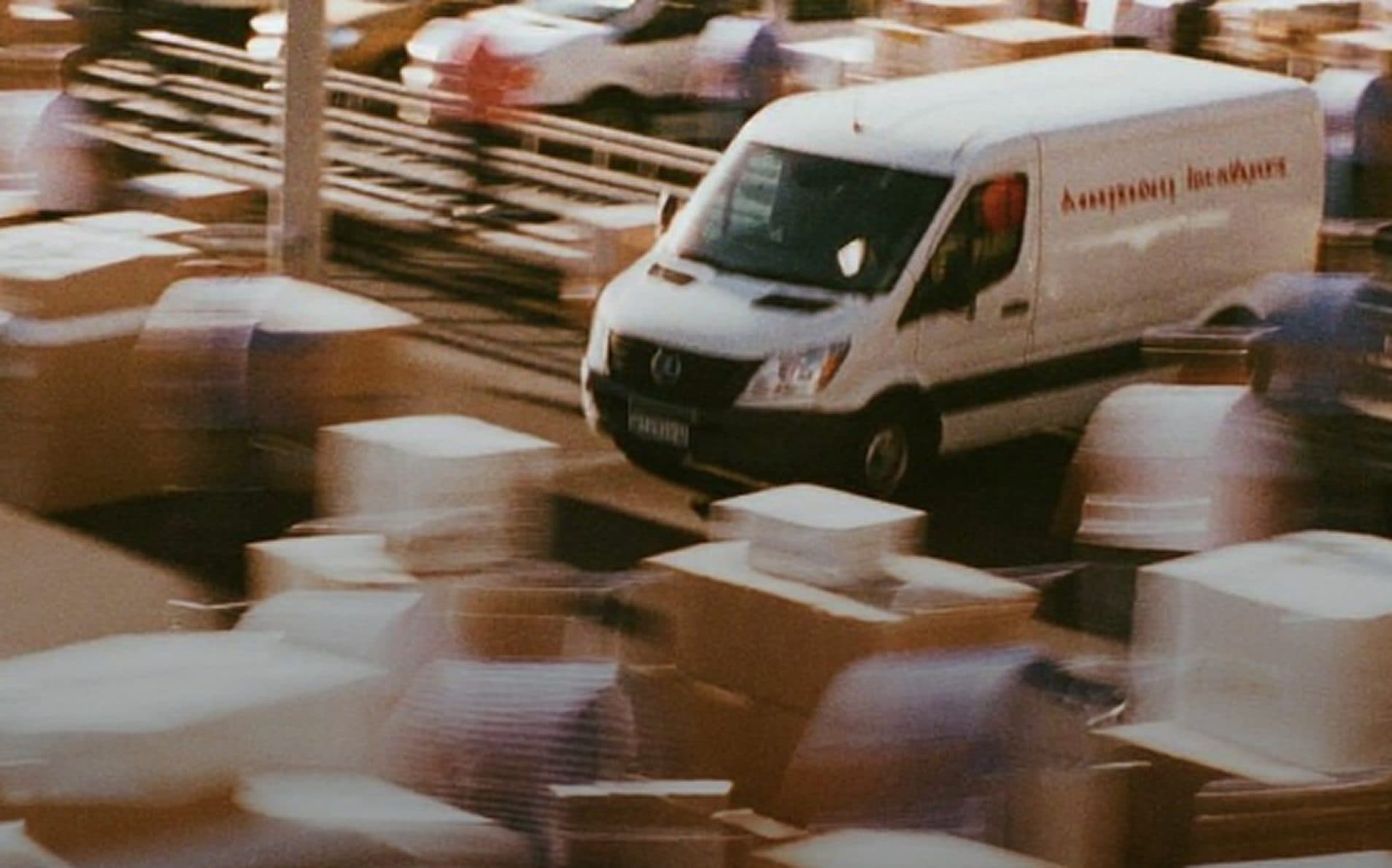 Delivery van moving through a blur of stacked packages